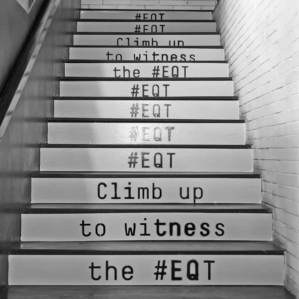 Staircase lettered Climb up to witness the #EQT