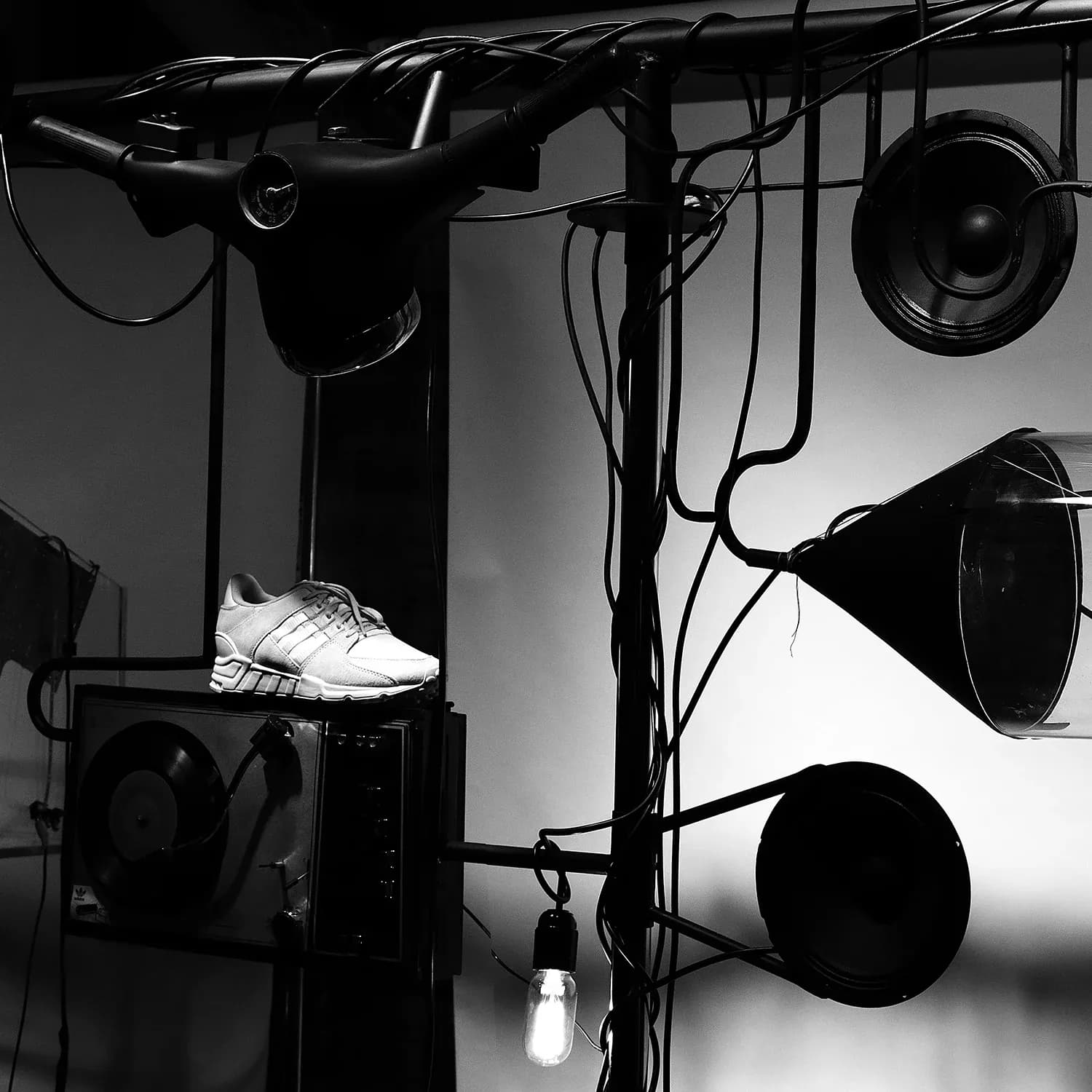 adidas EQT sneaker among hanging speakers and lamps