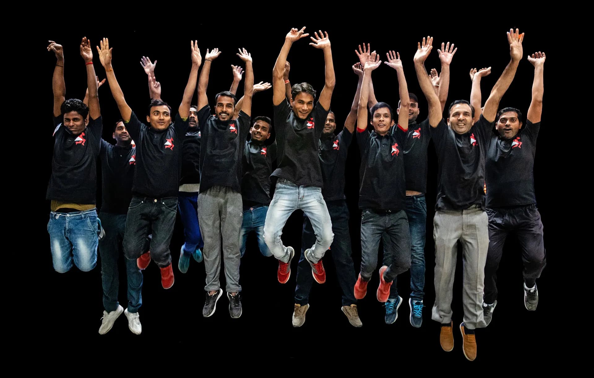 Delhivery team jumping in branded T-shirts