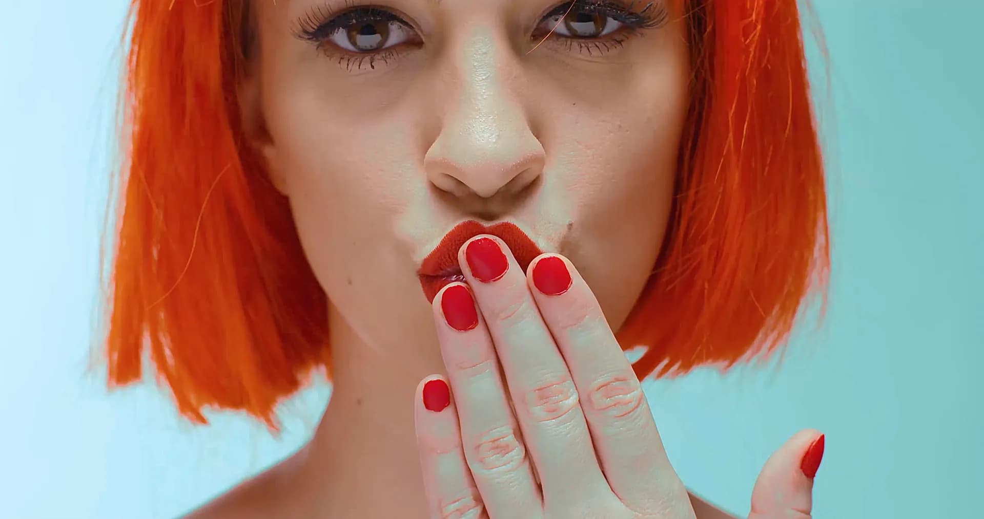 Woman with red hair blowing a kiss, OnePlus campaign